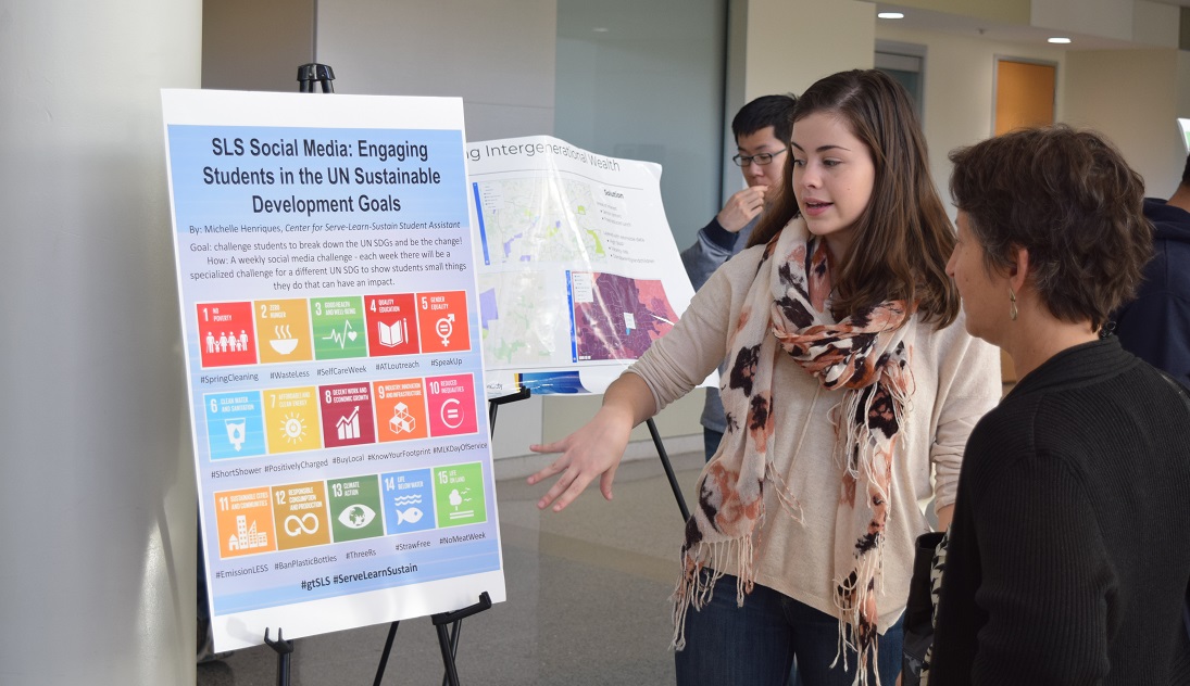 woman explaining to another the SDGs
